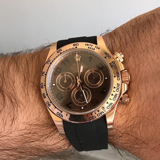 Gold dial Rolex Daytona with black rubber strap